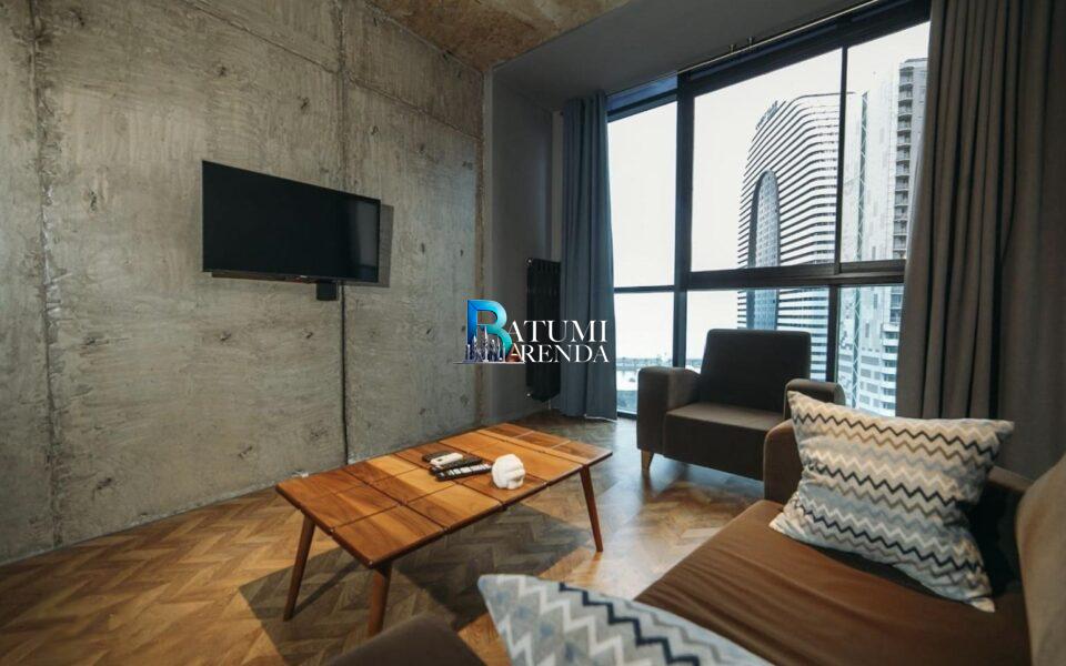 Гостиная с окном, телевизором и диваном в 2-комнатной квартире 50,5 м² в ЖК Dar Tower, район Химшиашвили, Батуми